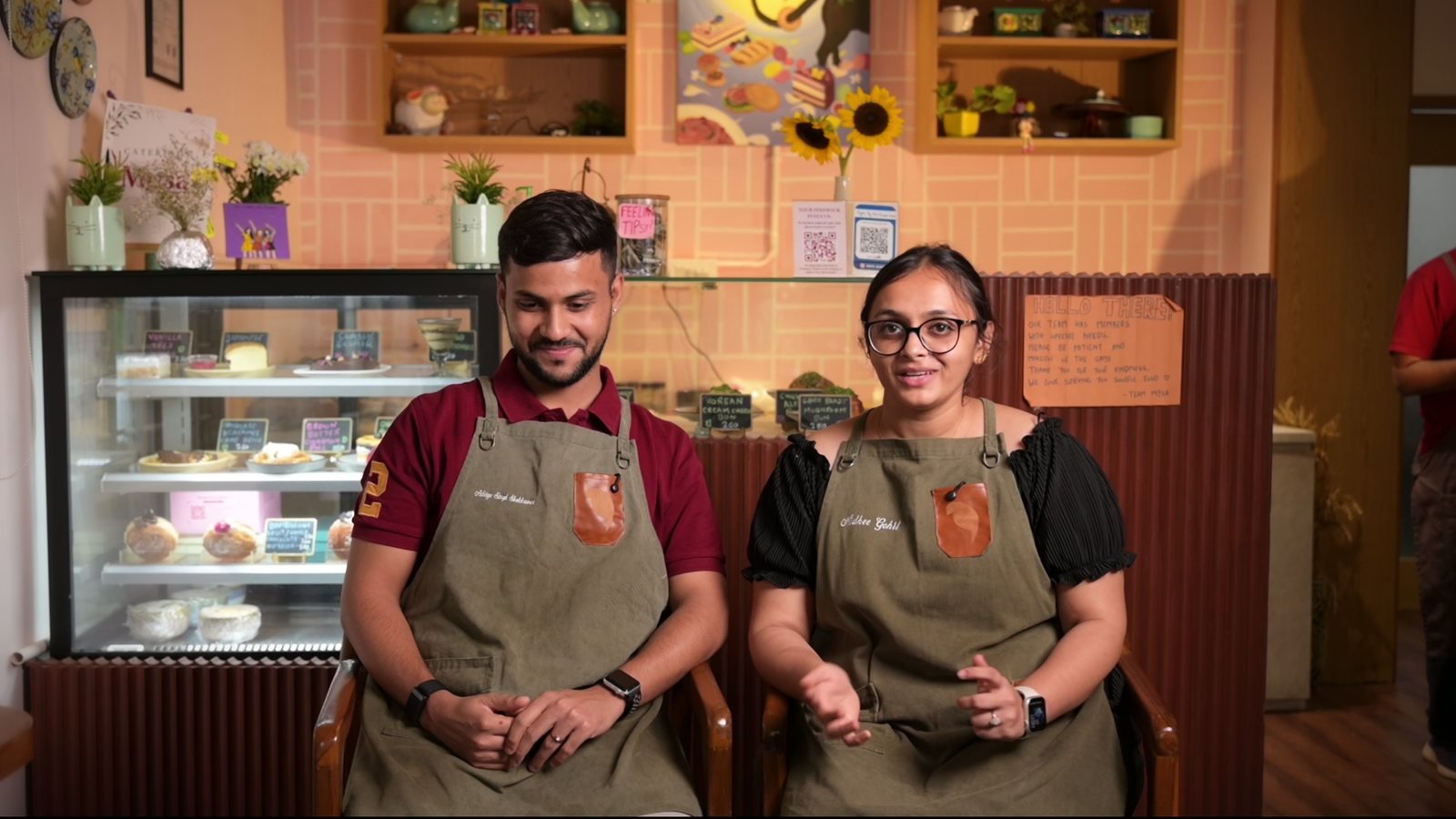 Two founders on camera inside their cafe