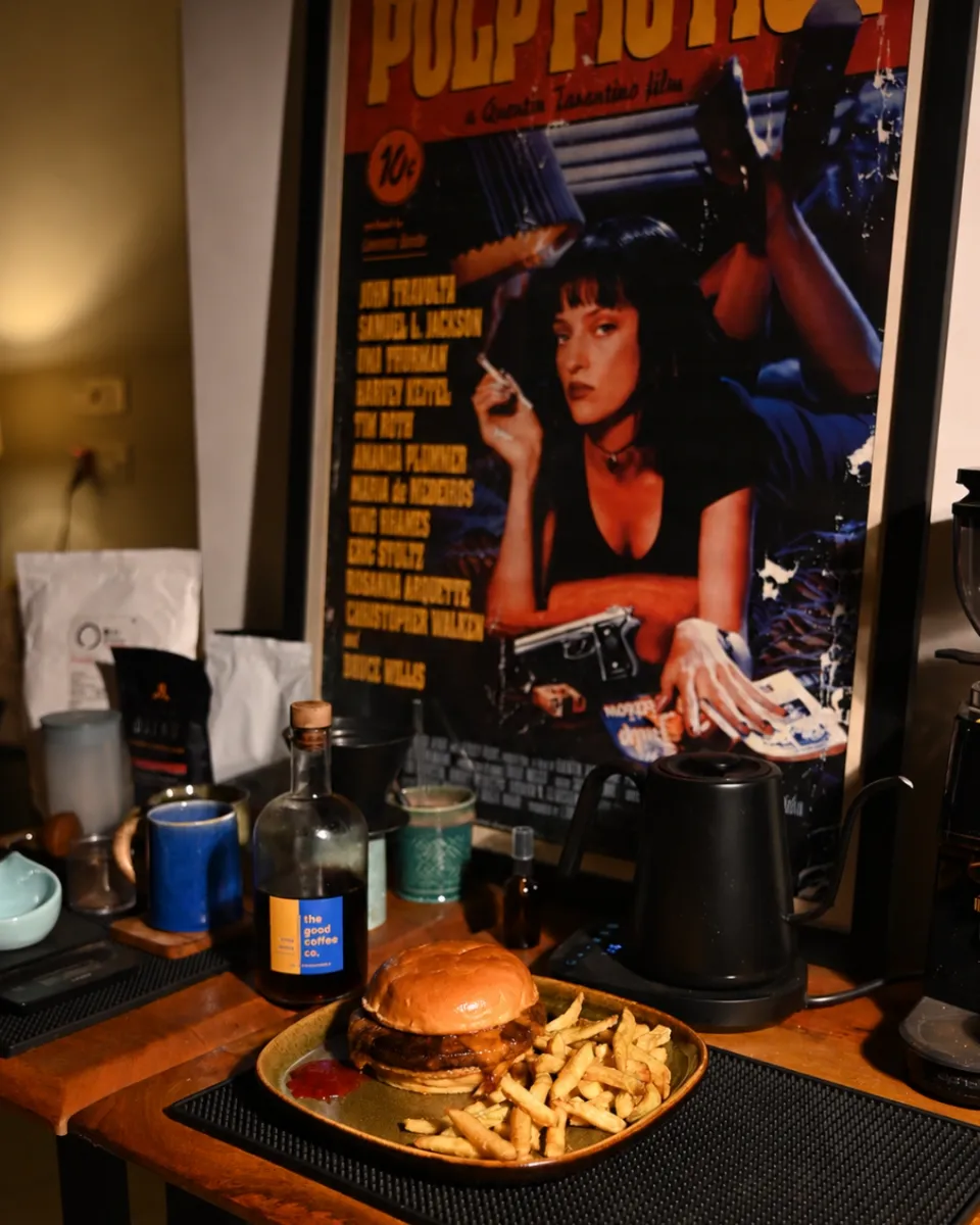 A bar counter under a printed poster, lit low