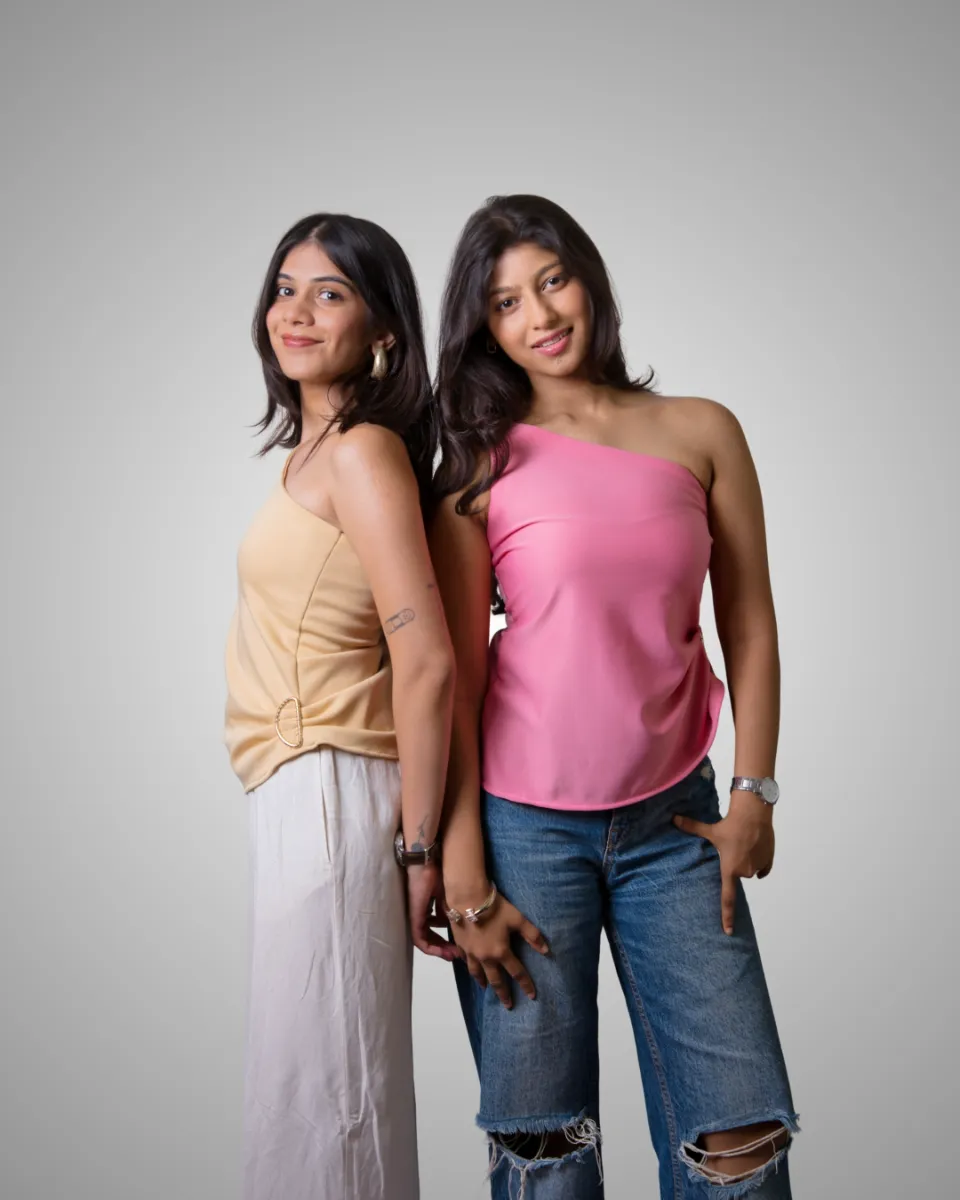 Two models side by side in tan and pink tops