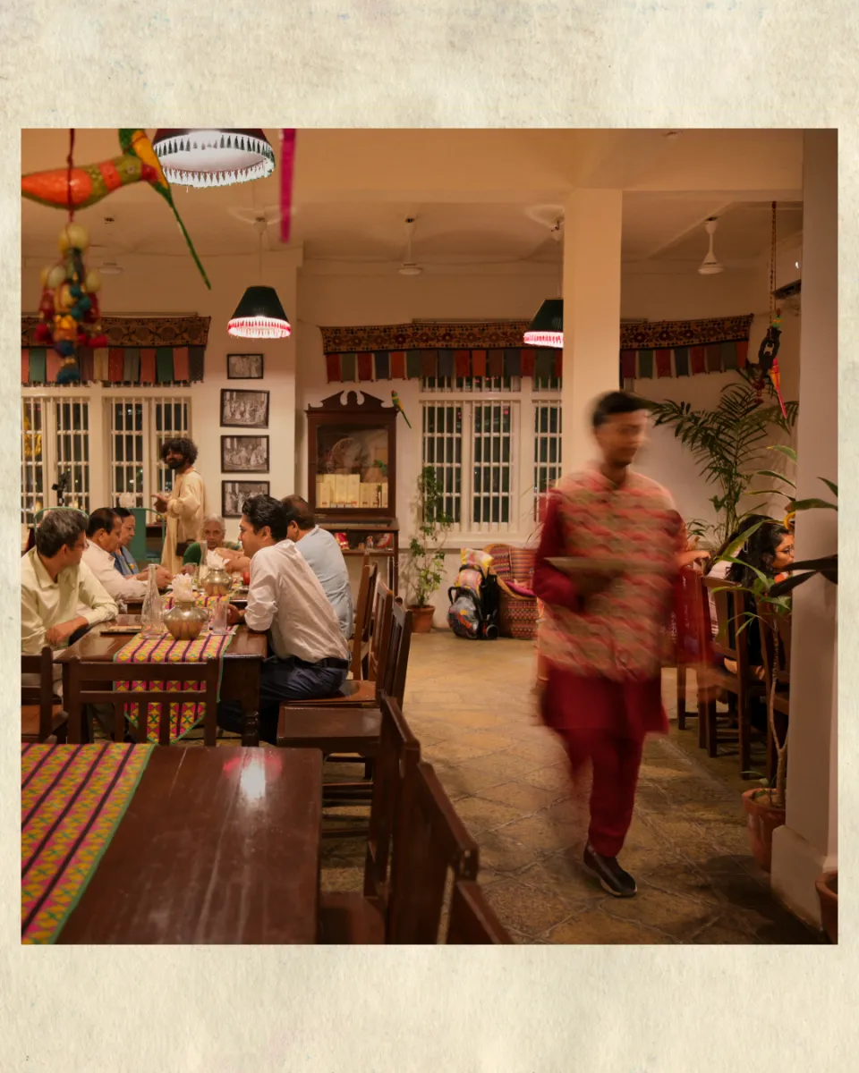 Diners at long tables in the Gazra Cafe dining room