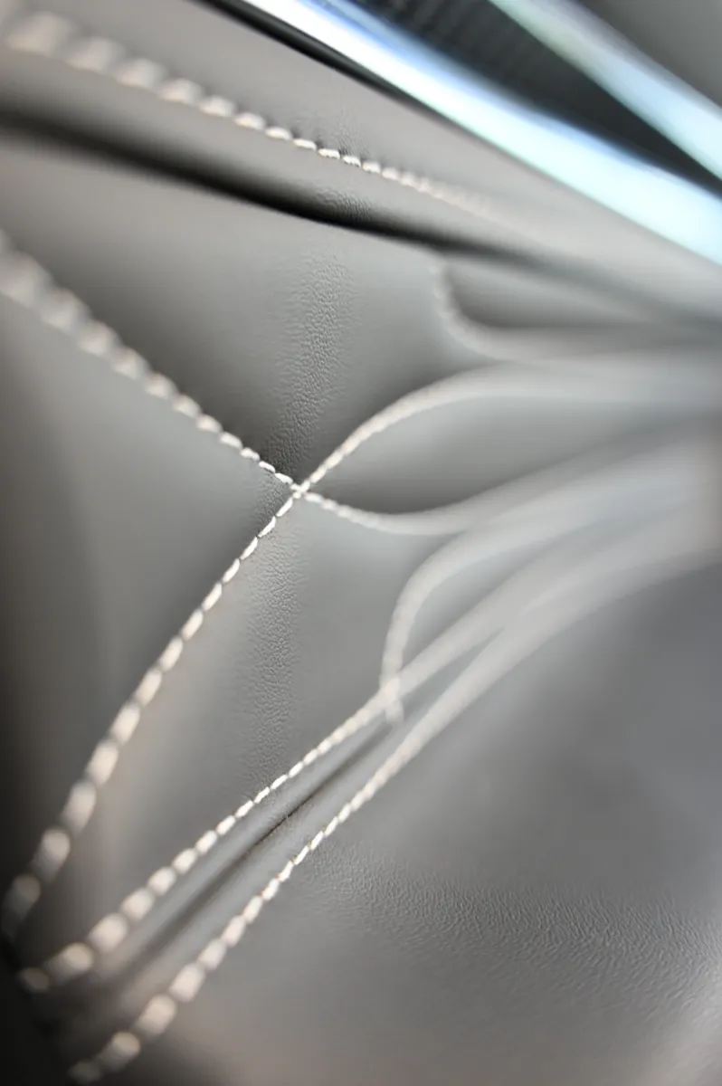 The shoulder line of a car body, lit to read the panel