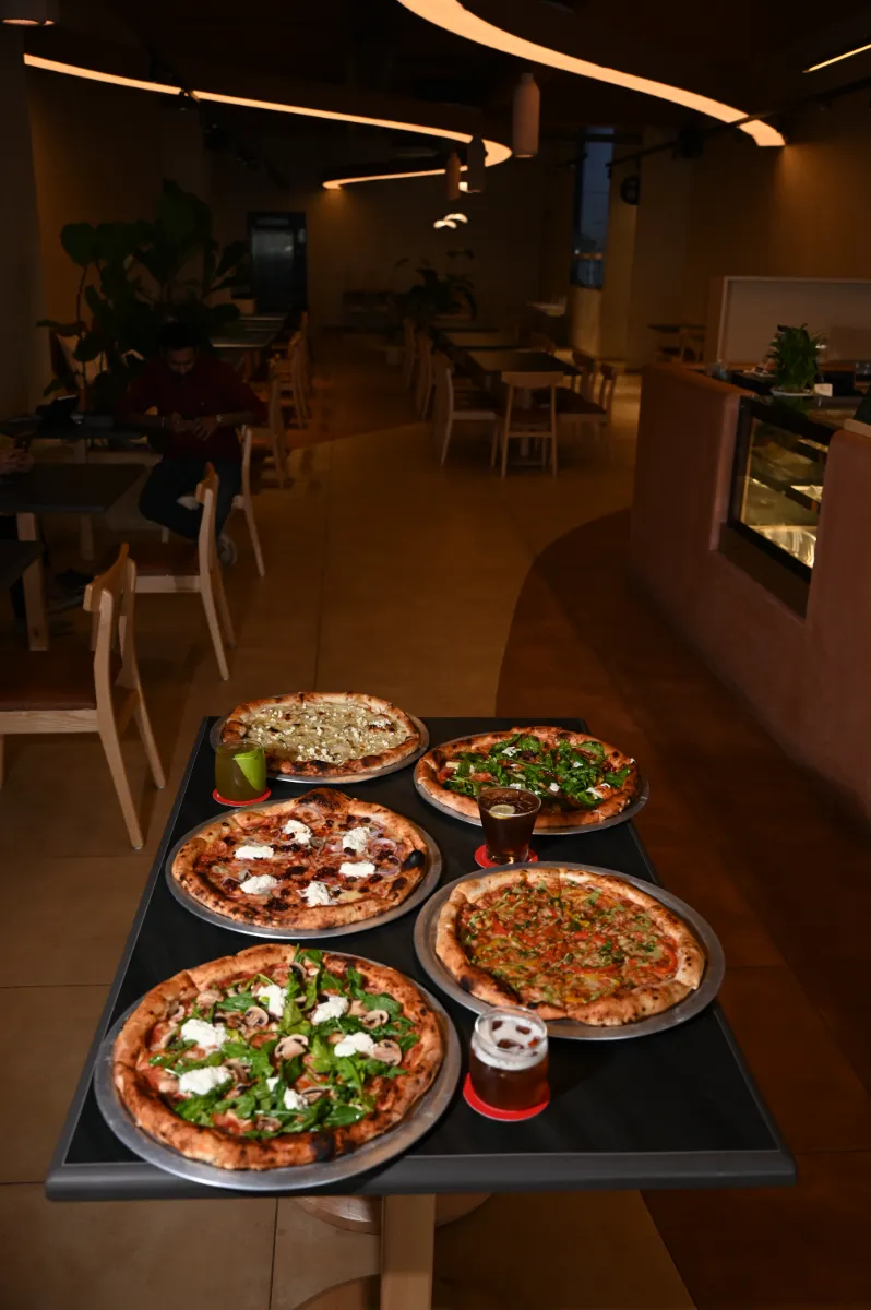 A table of pizzas in a restaurant dining room